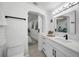 Modern bathroom boasts white cabinets, dark fixtures, and a toilet for convenience at 402 Pineapple St, Tarpon Springs, FL 34689