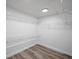Walk-in closet featuring shelving and hardwood floors, providing ample storage space at 402 Pineapple St, Tarpon Springs, FL 34689