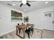 Bright dining room with modern decor, wood table, and stylish black chairs at 402 Pineapple St, Tarpon Springs, FL 34689