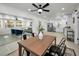 Open concept dining room featuring modern decor, wood table, and seamless flow to the living room and kitchen at 402 Pineapple St, Tarpon Springs, FL 34689