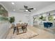 Open-concept dining area with wood table and black chairs connects to a cozy living space at 402 Pineapple St, Tarpon Springs, FL 34689