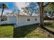 A view of the home exterior, showing its unique arched windows and landscaping at 402 Pineapple St, Tarpon Springs, FL 34689