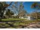 Well-maintained home on a spacious lot with mature trees and lush green grass at 402 Pineapple St, Tarpon Springs, FL 34689