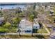 Charming single-story home with a covered porch, palm trees, and well-manicured lawn at 402 Pineapple St, Tarpon Springs, FL 34689