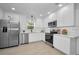 Bright kitchen with stainless steel appliances, white cabinetry and updated fixtures at 402 Pineapple St, Tarpon Springs, FL 34689