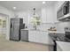 Bright kitchen with stainless steel appliances, white cabinetry and modern fixtures at 402 Pineapple St, Tarpon Springs, FL 34689