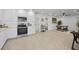Bright kitchen with stainless steel appliances, white cabinetry and an open layout at 402 Pineapple St, Tarpon Springs, FL 34689