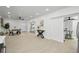 Open living space with kitchen and dining area, featuring modern furnishings and bright, neutral tones at 402 Pineapple St, Tarpon Springs, FL 34689