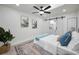 Stylish bedroom with barn door leading to the bathroom, complete with ceiling fan and modern decor at 402 Pineapple St, Tarpon Springs, FL 34689