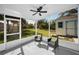 Enclosed patio with seating and a view of the backyard, perfect for relaxation and outdoor enjoyment at 402 Pineapple St, Tarpon Springs, FL 34689