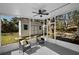 Charming screened porch with backyard view and ceiling fan at 402 Pineapple St, Tarpon Springs, FL 34689