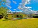 Screened-in pool with a lush green lawn and blue skies, perfect for outdoor relaxation and entertaining at 4293 Shrimp Ln, North Port, FL 34286