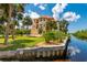 Beautiful waterfront home with lush landscaping and private dock, offering serene views and direct water access at 8731 Betty St, Port Richey, FL 34668
