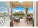 Outdoor balcony with comfortable seating, dining table, and a view of the lush garden and trees at 8731 Betty St, Port Richey, FL 34668