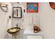 Unique powder room featuring distinctive sink basin, ornate mirror, and decorative accents at 8731 Betty St, Port Richey, FL 34668