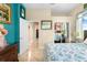 Comfortable bedroom with a large bed, open doorway, wood dresser, and a window letting in natural light at 8731 Betty St, Port Richey, FL 34668