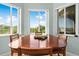Formal dining room showcasing a dining table with seating for six and multiple windows offering scenic views at 8731 Betty St, Port Richey, FL 34668