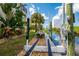 Private boat lift providing convenient access to the water, surrounded by lush landscaping and clear skies at 8731 Betty St, Port Richey, FL 34668