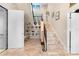 Grand entryway with decorative staircase, white shelving, and a tile floor that invites you inside at 8731 Betty St, Port Richey, FL 34668