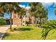 Elegant home boasts beautiful landscaping, a spacious driveway, and an attached two-car garage with a separate carport at 8731 Betty St, Port Richey, FL 34668