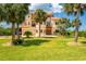 Beautiful two-story home featuring lush landscaping, a well-manicured lawn, and an attached two-car garage at 8731 Betty St, Port Richey, FL 34668