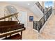 Elegant entrance foyer featuring beautiful tile floors, a Steinway piano, staircase and classic decor at 8731 Betty St, Port Richey, FL 34668