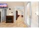 Hallway featuring gorgeous travertine floors, fireplace, and access to other rooms at 8731 Betty St, Port Richey, FL 34668