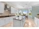 Bright, modern kitchen with stainless steel appliances, granite counters, tile floors and ample natural light at 8731 Betty St, Port Richey, FL 34668