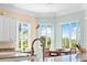 Bright kitchen featuring granite countertops, light cabinetry, and a breakfast nook with large windows and scenic outdoor views at 8731 Betty St, Port Richey, FL 34668