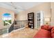 Open landing featuring a bookshelf, iron railing, and views of the waterway at 8731 Betty St, Port Richey, FL 34668
