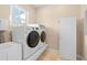 Functional laundry room with modern washer, dryer, sink, and storage space, perfect for daily chores at 8731 Betty St, Port Richey, FL 34668