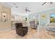 Open-concept living room featuring tile floors, a ceiling fan, and a view of the kitchen and backyard at 8731 Betty St, Port Richey, FL 34668