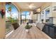 Inviting covered patio with comfortable seating, wood table, outdoor TV, and peaceful waterfront view at 8731 Betty St, Port Richey, FL 34668