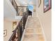 Elegant staircase with decorative wrought iron railing and tile steps, leading to the upper level of the home at 8731 Betty St, Port Richey, FL 34668