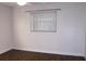 The light-filled bedroom features wood-look floors, neutral paint, and a window with blinds at 9705 45Th N Way, Pinellas Park, FL 33782