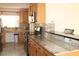 Spacious kitchen with stainless appliances, granite countertops, mosaic tile backsplash and a built-in desk area at 9705 45Th N Way, Pinellas Park, FL 33782