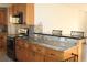 Beautiful kitchen with granite counters, a breakfast bar, stainless appliances, mosaic backsplash and updated cabinetry at 9705 45Th N Way, Pinellas Park, FL 33782