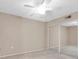 Bright, neutral bedroom featuring mirrored closet doors and a ceiling fan at 19029 Us Highway 19 N # 26-304, Clearwater, FL 33764