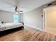 Bright bedroom with ceiling fan, wood floors, and window view at 225 Country Club Dr # 1611, Largo, FL 33771