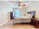 Cozy bedroom with wood floors, ceiling fan, and natural light from the window at 225 Country Club Dr # 1611, Largo, FL 33771