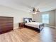 Bedroom features wood-look flooring, ceiling fan with light, and a matching dark wood bedroom set at 225 Country Club Dr # 1611, Largo, FL 33771