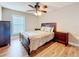 Comfortable bedroom with wood-look floors, neutral walls, and ceiling fan at 225 Country Club Dr # 1611, Largo, FL 33771