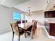 Inviting dining area featuring an elegant chandelier, large table, and seating for eight at 225 Country Club Dr # 1611, Largo, FL 33771