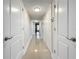 Hallway with tile flooring, white doors, and neutral wall paint at 225 Country Club Dr # 1611, Largo, FL 33771