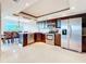 Bright kitchen boasts stainless appliances, granite counters, and adjacent dining area with ocean view at 225 Country Club Dr # 1611, Largo, FL 33771