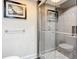 Tiled shower with glass door and decorative accents at 225 Country Club Dr # 1611, Largo, FL 33771