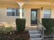 Inviting home entrance featuring a black door with glass inset, surrounded by well-maintained landscaping and concrete steps at 2465 Northside Dr # 1203, Clearwater, FL 33761