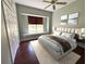Comfortable bedroom featuring a large window with blinds, neutral walls, and a ceiling fan at 2850 Deer Run, Tarpon Springs, FL 34688