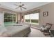 Comfortable bedroom with a view of the pool area, chair, and ceiling fan at 2850 Deer Run, Tarpon Springs, FL 34688