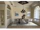 Elegant dining room featuring a tray ceiling, modern chandelier, and stylish decor elements at 2850 Deer Run, Tarpon Springs, FL 34688